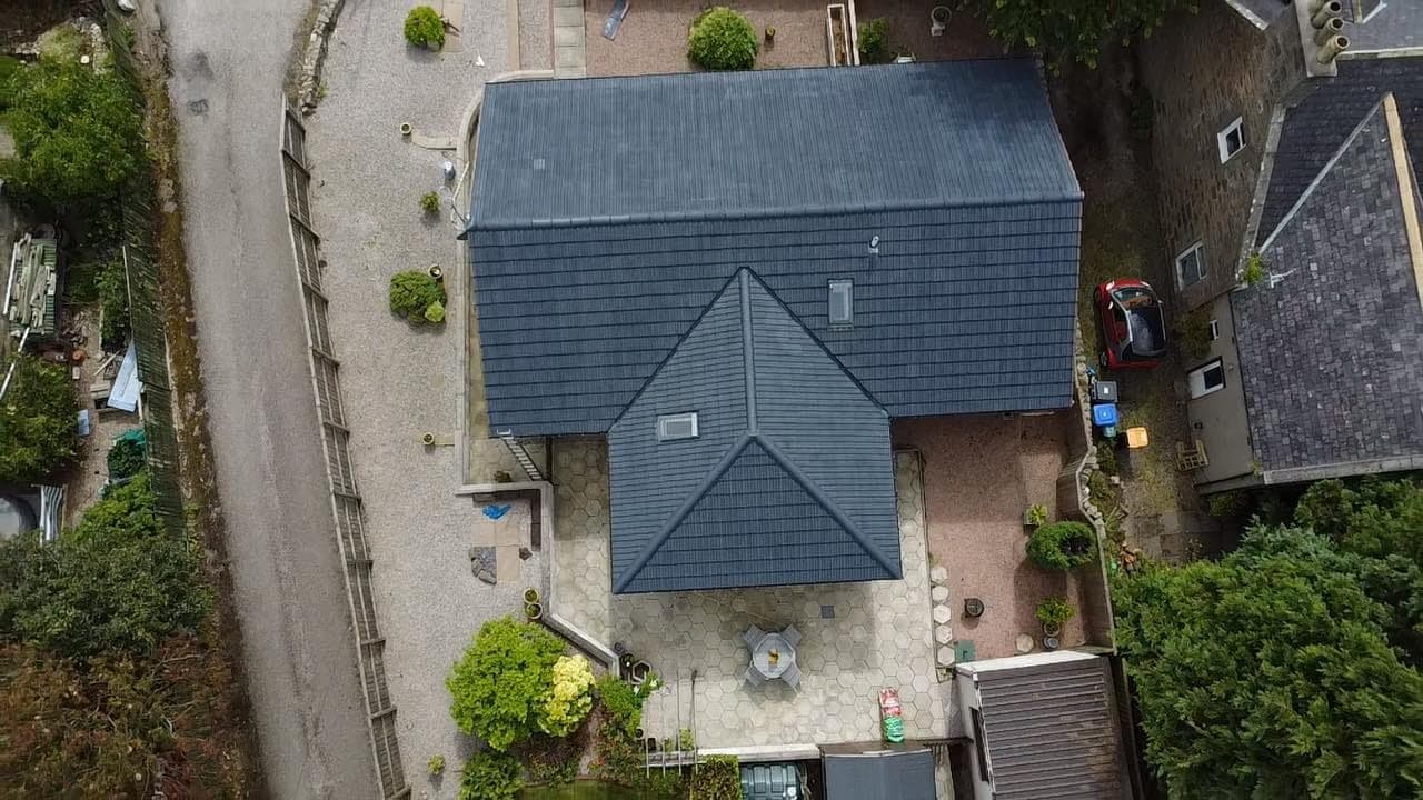 Aerial view of a roof with a dark refreshed exterior coating.
